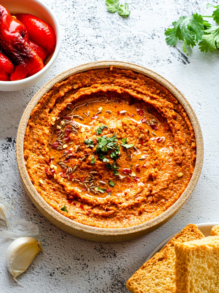 Muhammara in a bowl with Olive Oil drizzle.