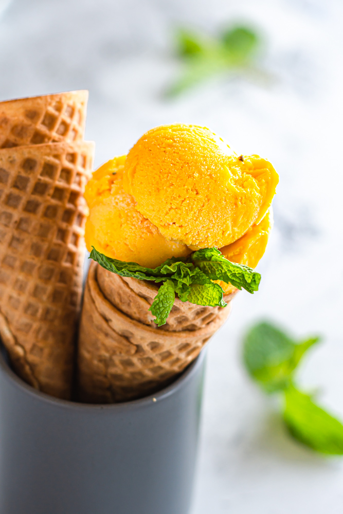 Mango Coconut Ice Cream in a cone.